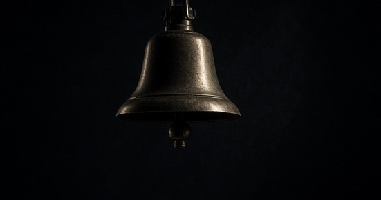 A brass training bell suspended in a dark fictional gym