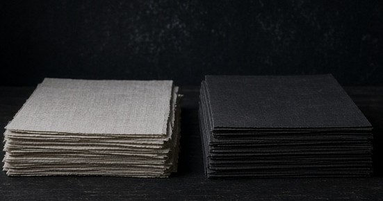 Two separate stacks of unmarked paper representing app and website