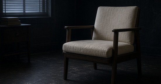 An empty chair beside an unmarked reading table